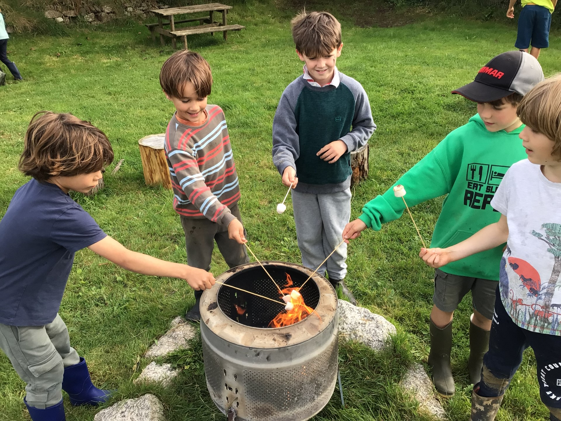 children toasting marshmallows over the firepit