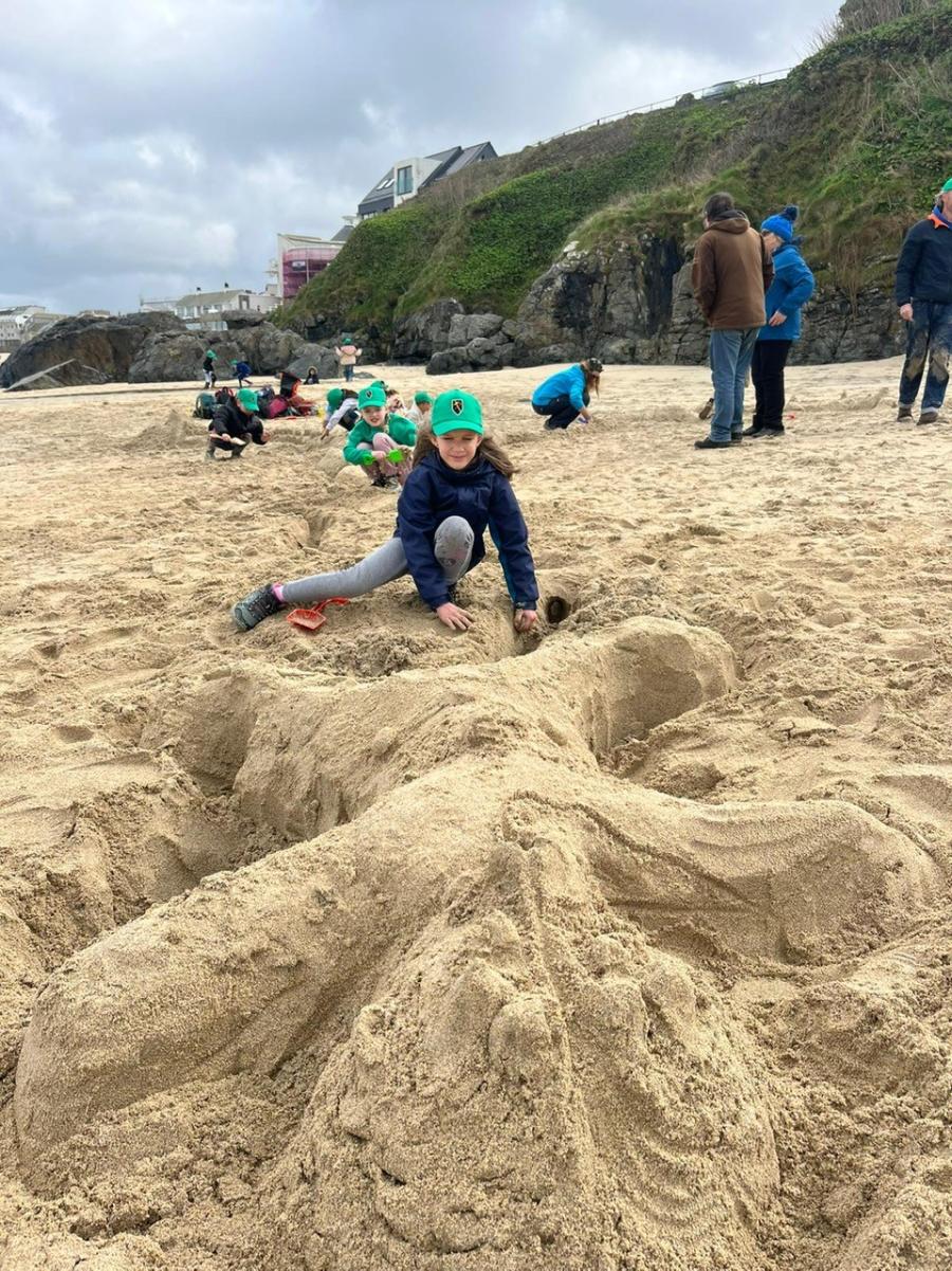 creating sand art at the beach